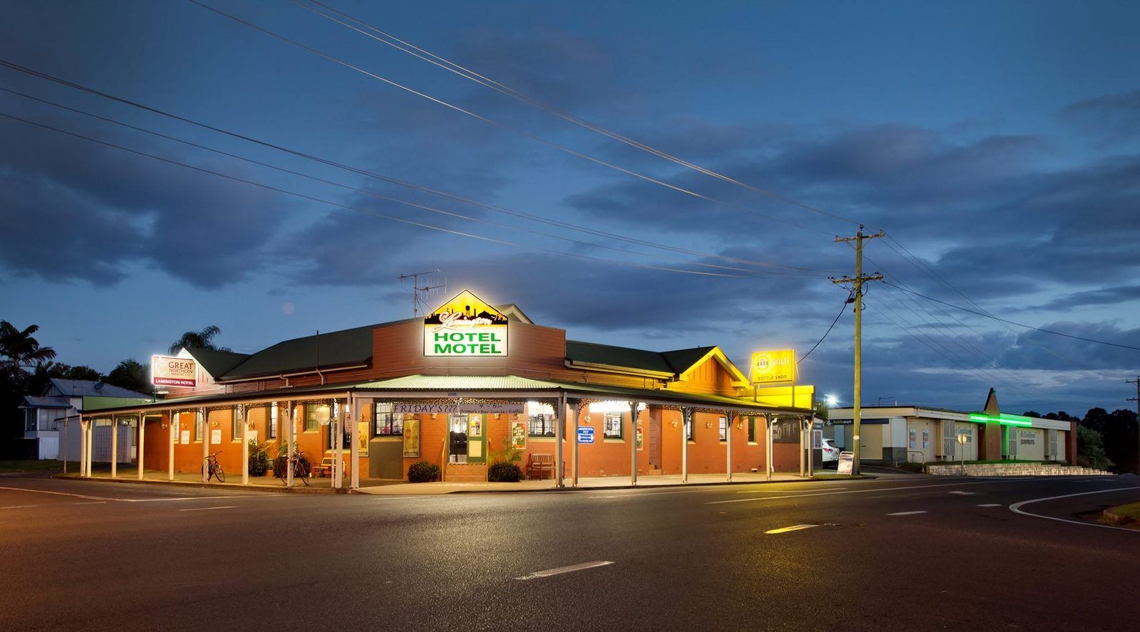 The Lamington Hotel Motel at dusk, lights on, corner of Queen and Ferry Streets